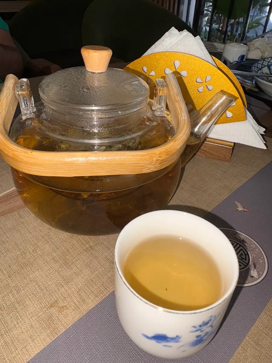 Glass teapot of fresh tea