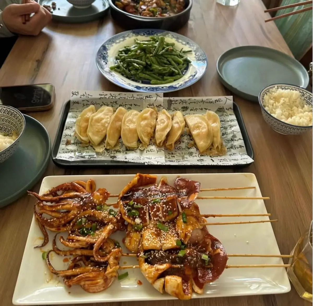 Banquet spread of dumplings, greens and seafood