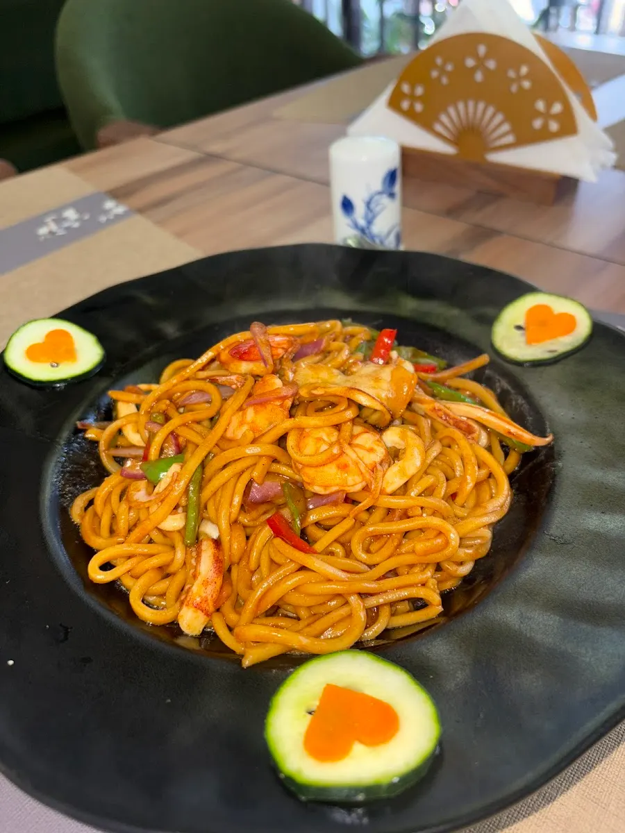 Noodles with egg on a dark plate