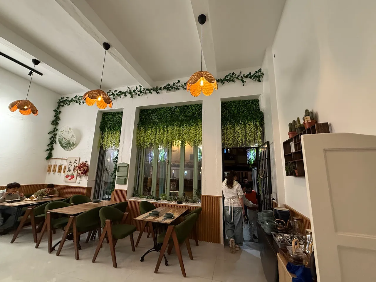 Bright dining room with pendant lamps and plants